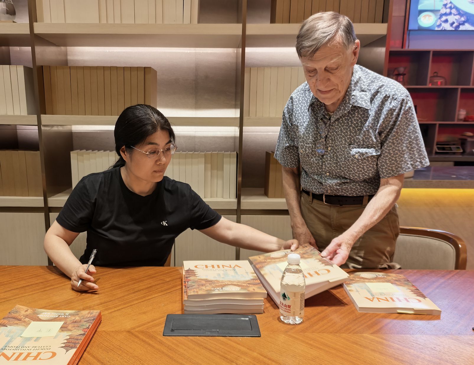 Wei and Gary signing books