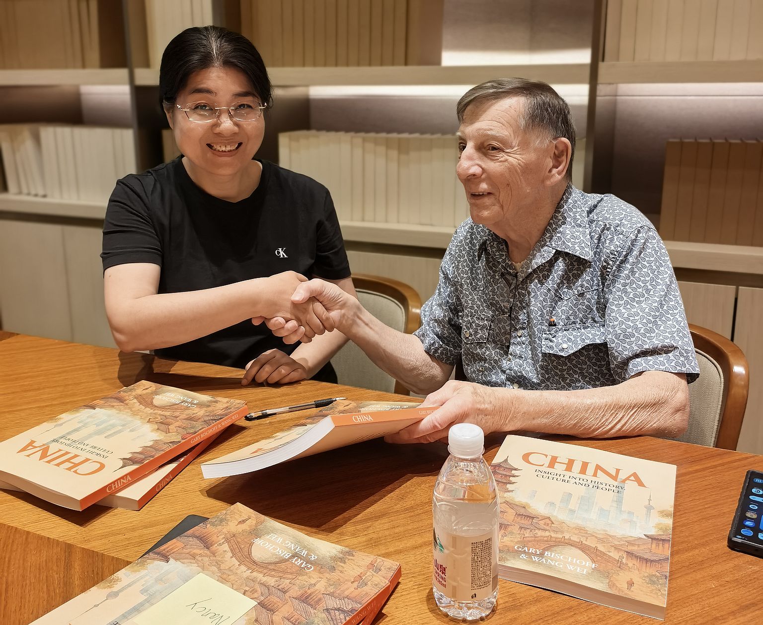 Wei and Gary signing books