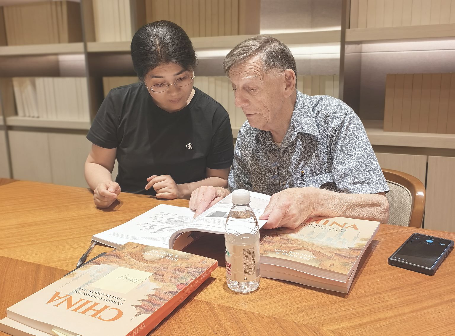Wei and Gary signing books