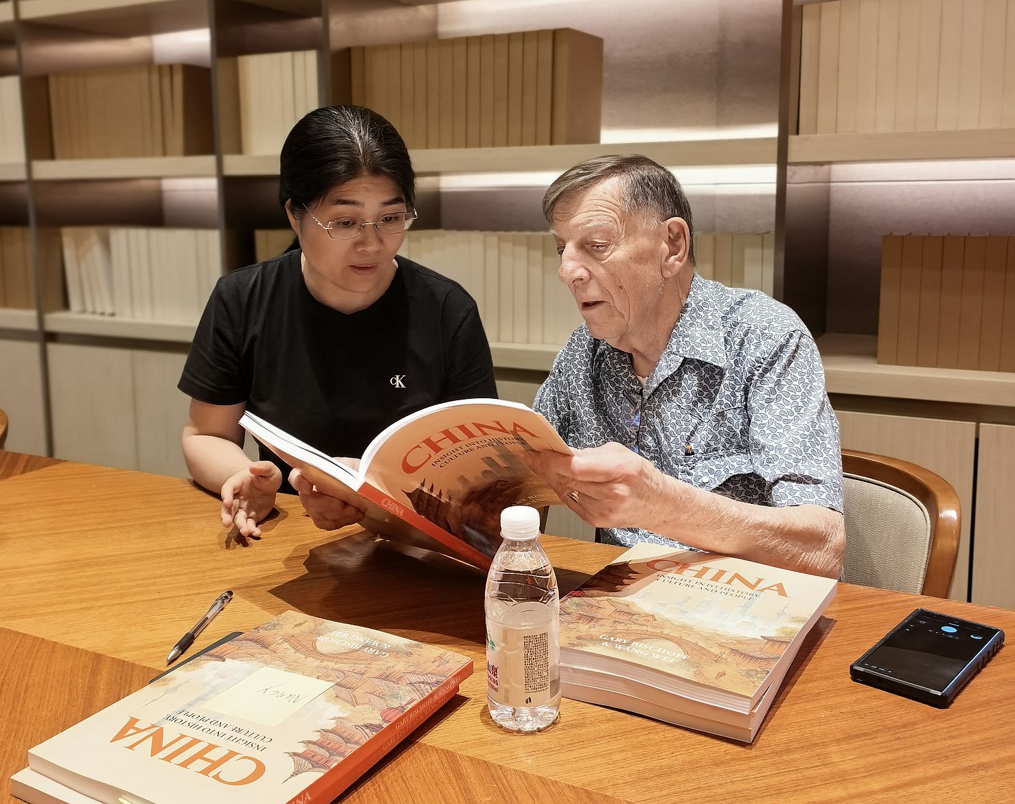Wei and Gary signing books